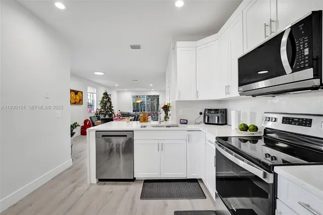 a kitchen with a sink cabinets and stainless steel appliances