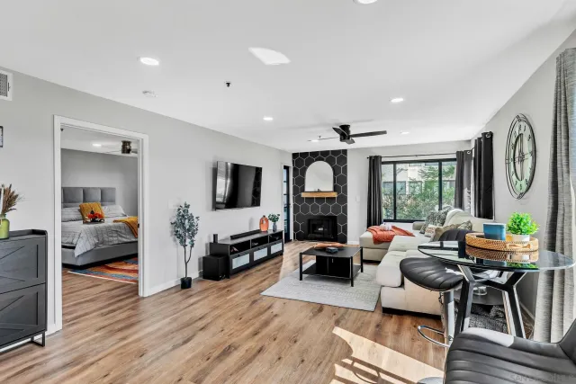a living room with furniture flat screen tv and a fireplace