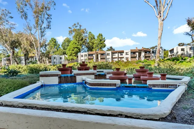 a view of a house with a yard and sitting area