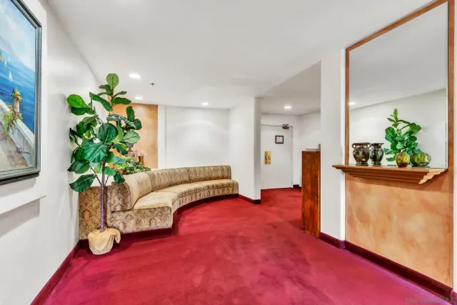 a living room with furniture and a potted plant