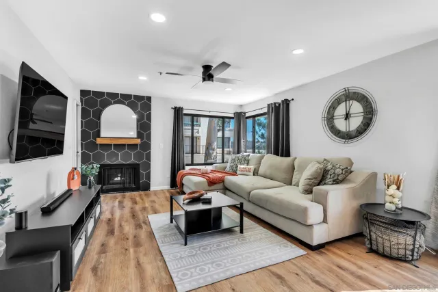 a living room with fireplace furniture and a flat screen tv