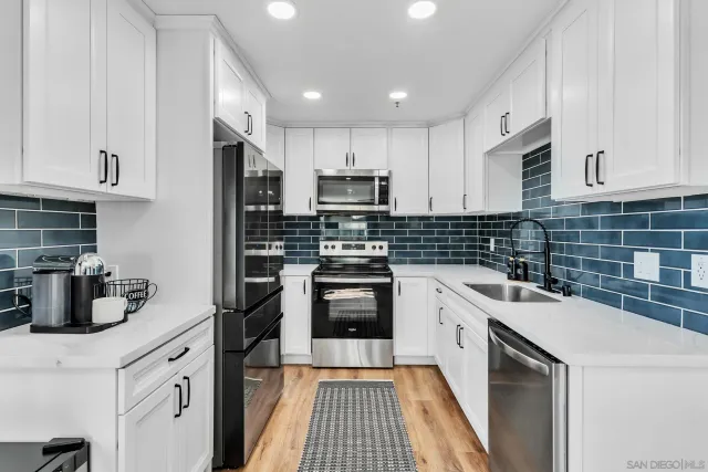 a kitchen with a sink stove and cabinets