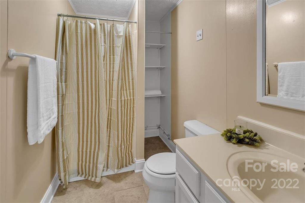 206 Star Ridge Road Canton, NC 28716 - Photo 23 of 29 a white toilet sitting next to a bathroom sink and a tub