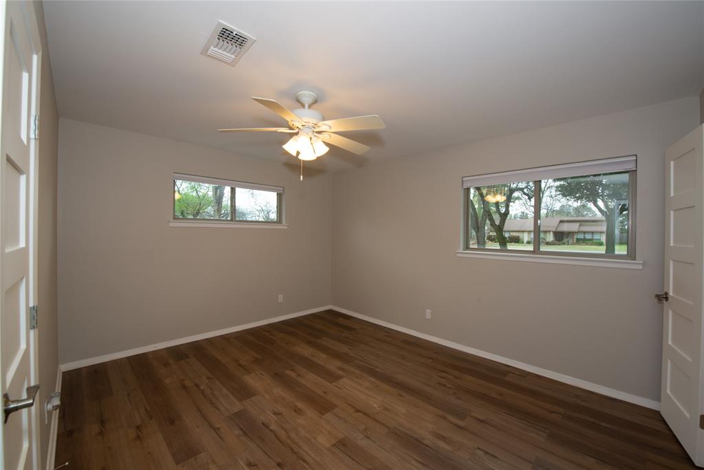 2124 Ridge Lane Grapevine, TX 76051 - Photo 14 of 17 Unfurnished room with dark wood-style floors and ceiling fan