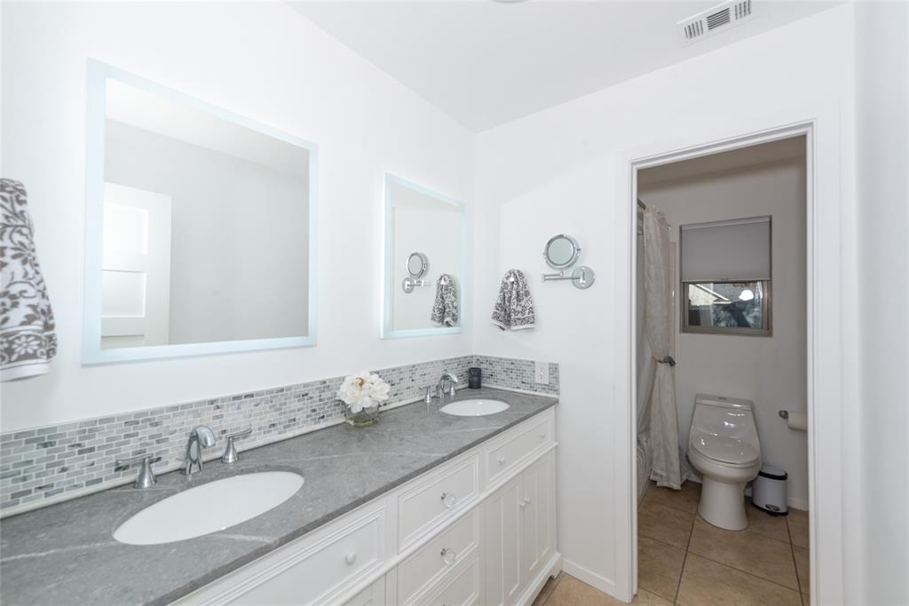 2124 Ridge Lane Grapevine, TX 76051 - Photo 16 of 23 a bathroom with a granite countertop sink mirror and toilet
