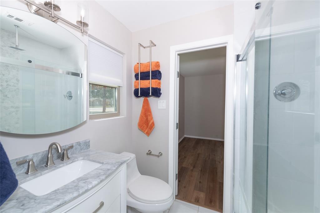 2124 Ridge Lane Grapevine, TX 76051 - Photo 18 of 23 a bathroom with a granite countertop sink toilet and shower
