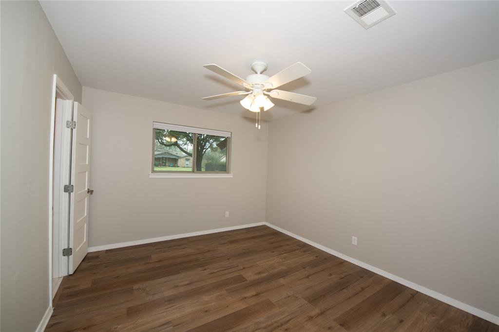 2124 Ridge Lane Grapevine, TX 76051 - Photo 19 of 23 an empty room with wooden floor and ceiling fan