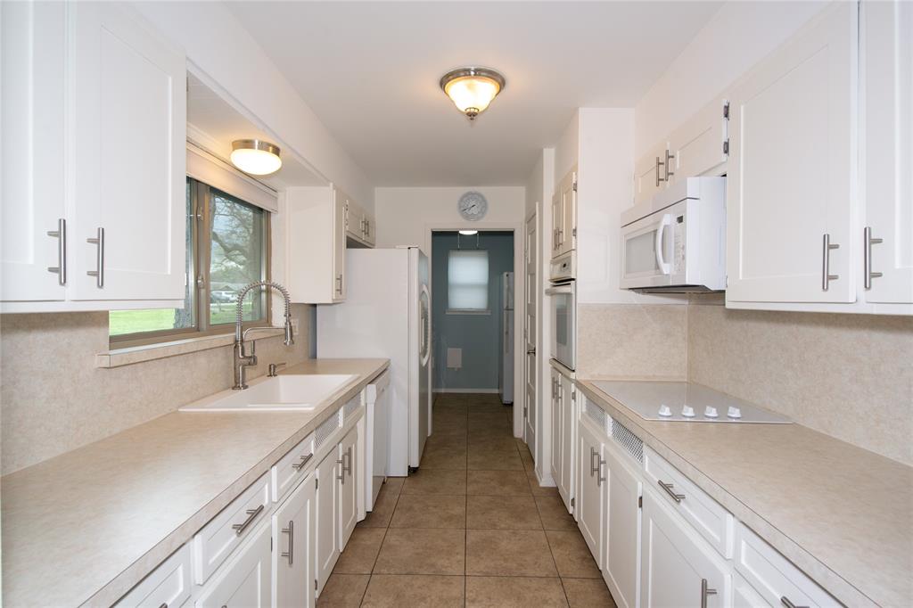 2124 Ridge Lane Grapevine, TX 76051 - Photo 4 of 17 Kitchen with white cabinetry, white appliances, light countertops, and light tile patterned floors