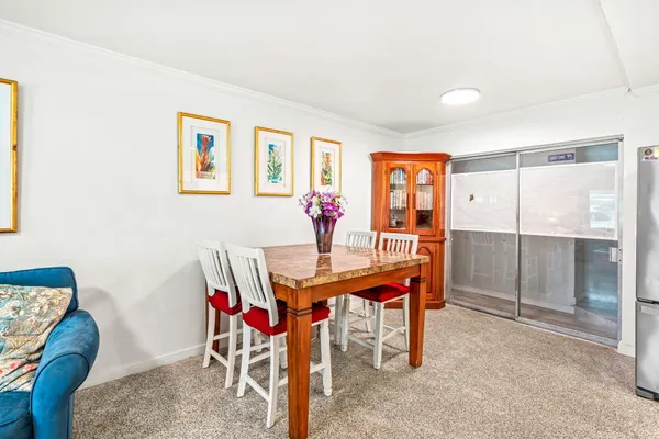 a view of a patio with couches table and chairs with wooden floor