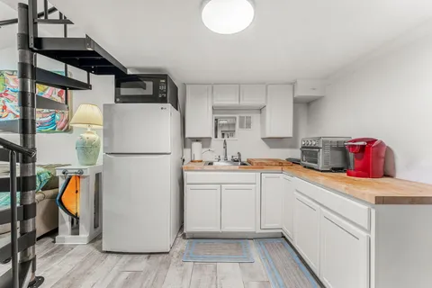 a kitchen with refrigerator and cabinets