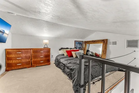 a bedroom with a bed and a mirror