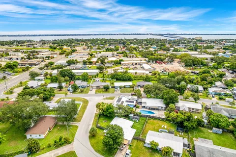 a view of a golf ground with huge green field and trees