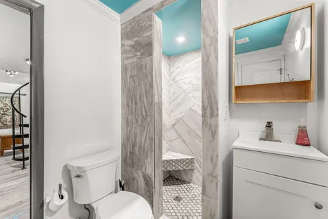 a bathroom with a sink toilet and shower