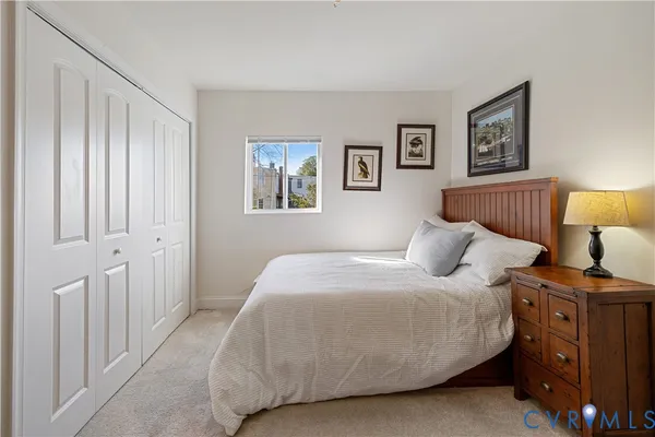 a bedroom with a bed and night stand