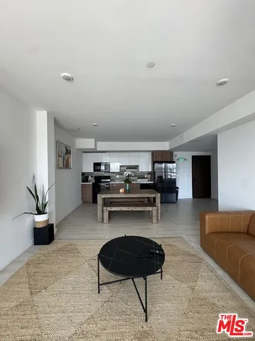 a view of a dining room with furniture large windows and wooden floor