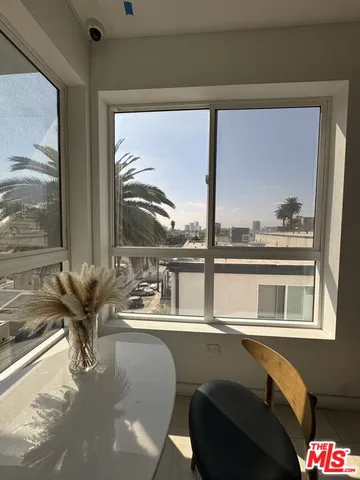 a living room with hardwood floor and a large window