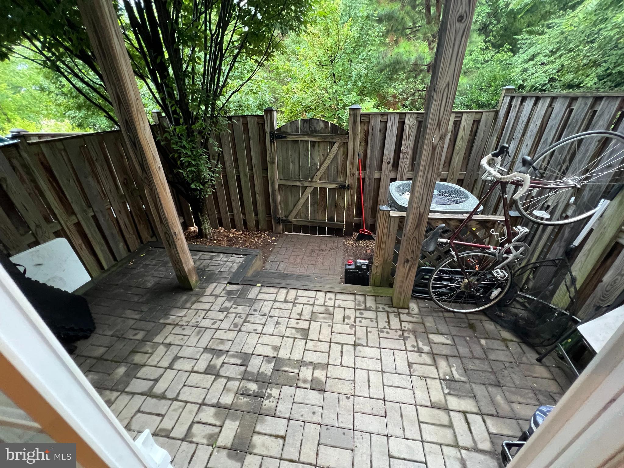 8193 Falls Grove Drive Manassas, VA 20111 - Photo 11 of 27 a view of a backyard with wooden fence and a large tree