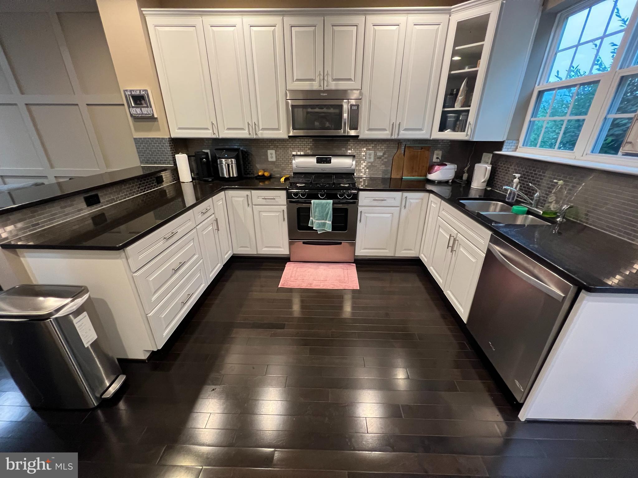8193 Falls Grove Drive Manassas, VA 20111 - Photo 16 of 27 a kitchen with granite countertop stainless steel appliances and wooden cabinets