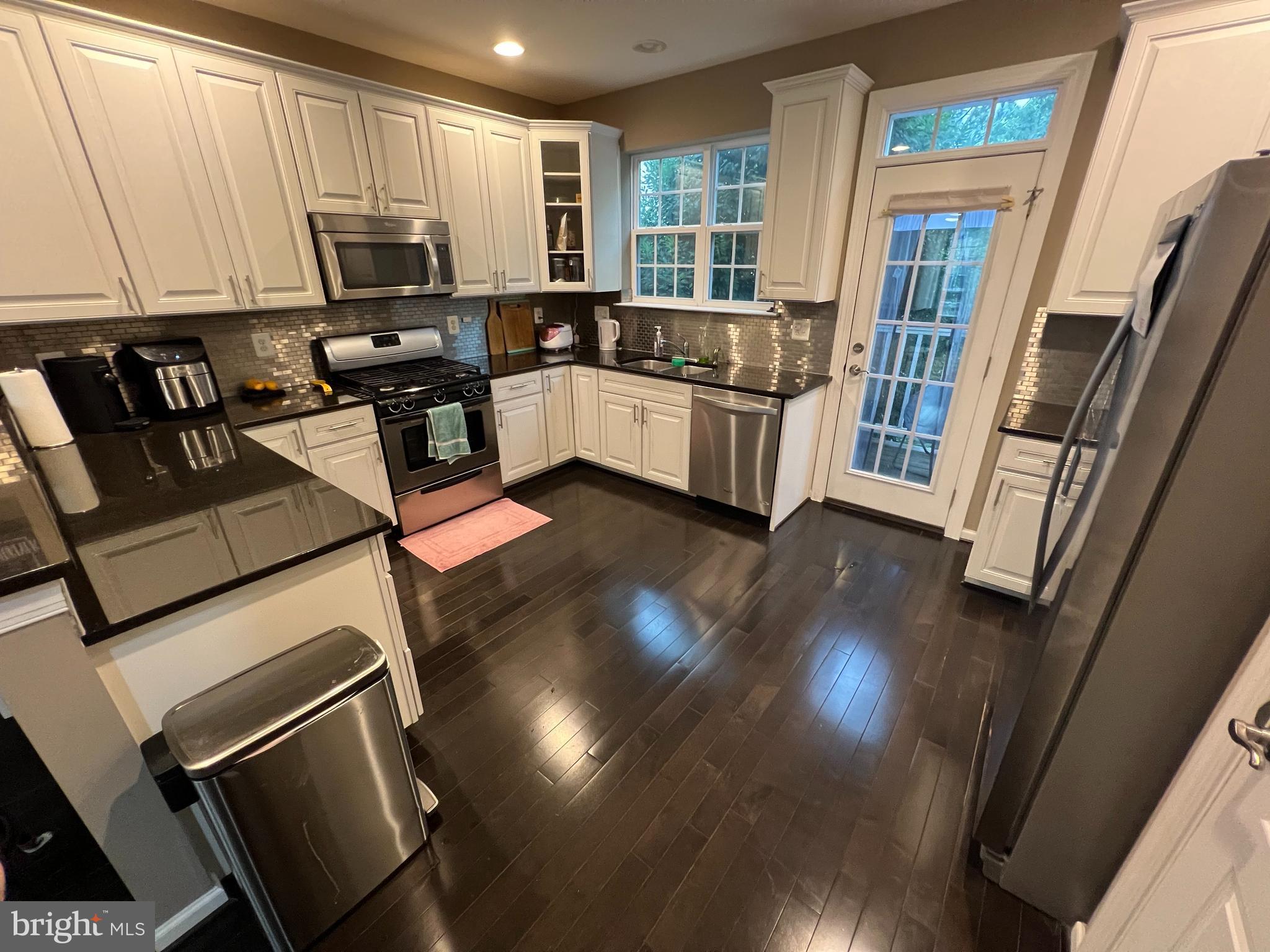 8193 Falls Grove Drive Manassas, VA 20111 - Photo 17 of 27 a view of a kitchen with furniture and a window