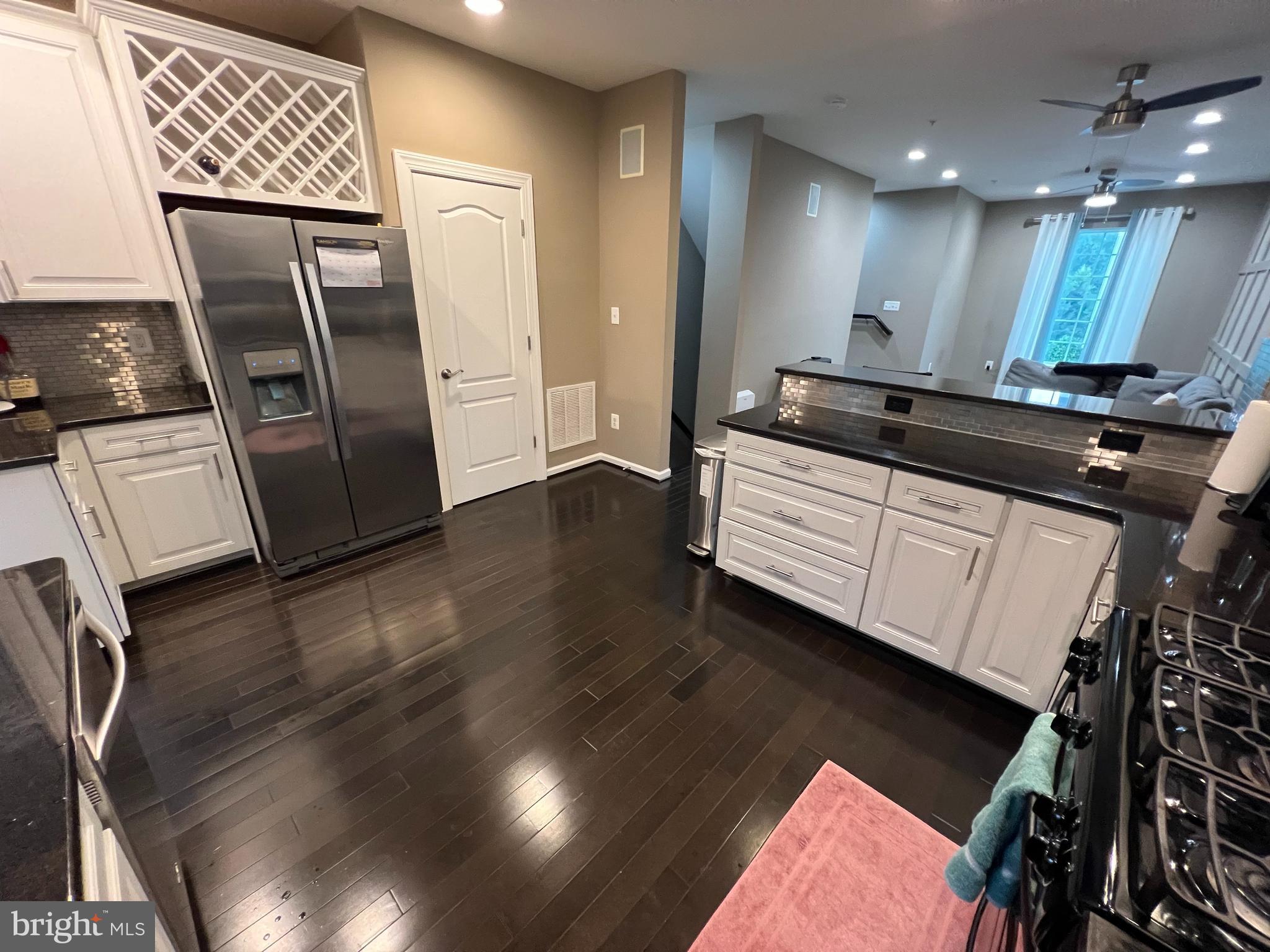 8193 Falls Grove Drive Manassas, VA 20111 - Photo 19 of 27 a view of a hallway with wooden floor