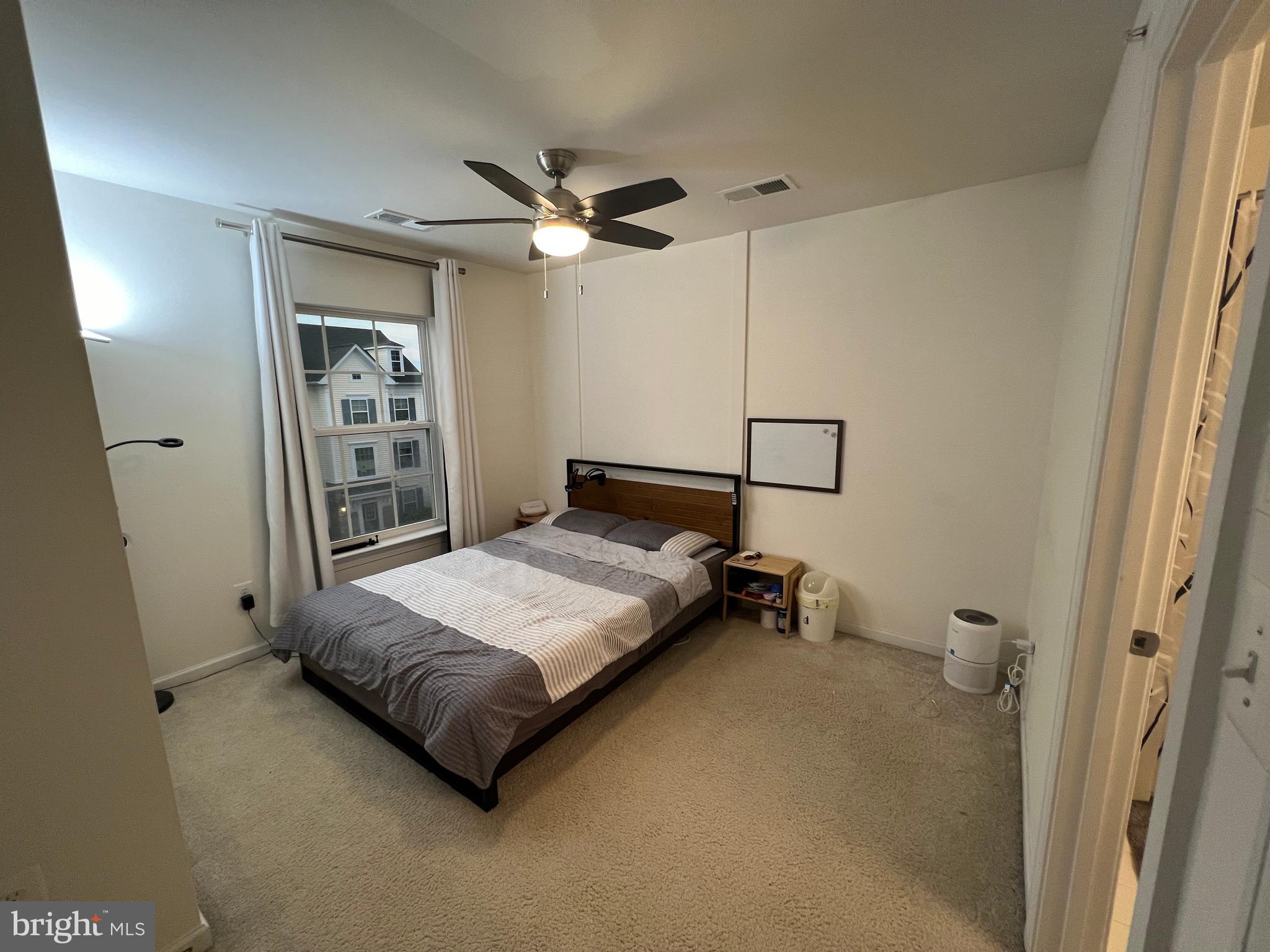 8193 Falls Grove Drive Manassas, VA 20111 - Photo 25 of 27 a bedroom with a bed and a chandelier