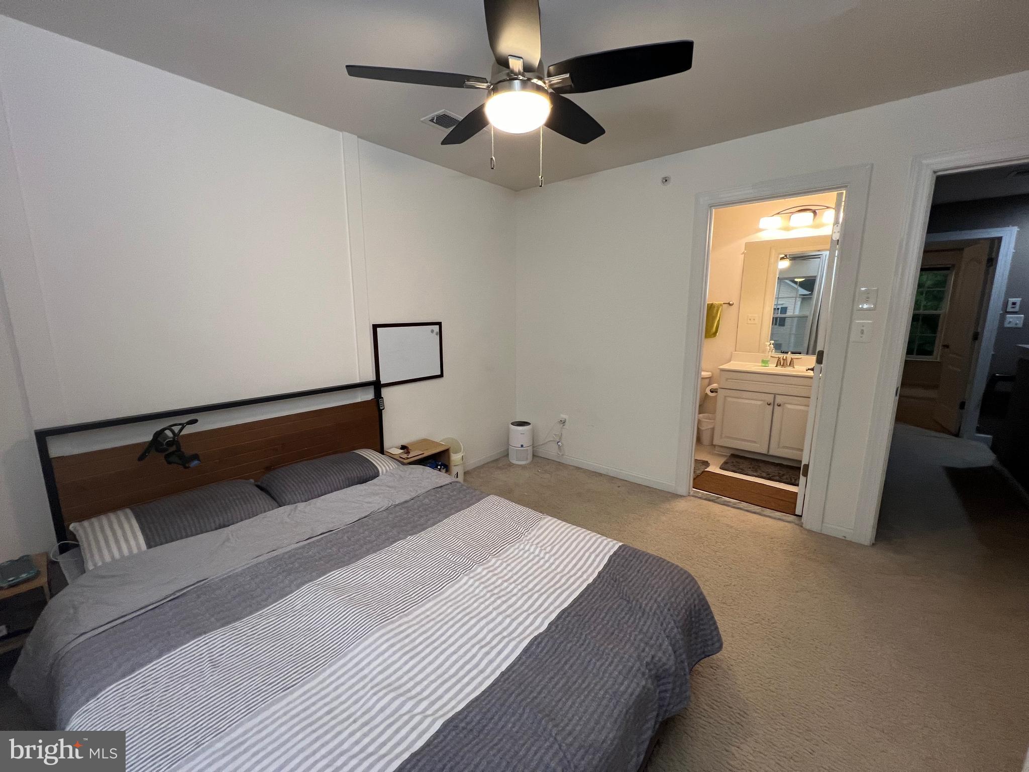 8193 Falls Grove Drive Manassas, VA 20111 - Photo 26 of 27 a bedroom with a bed and a chandelier