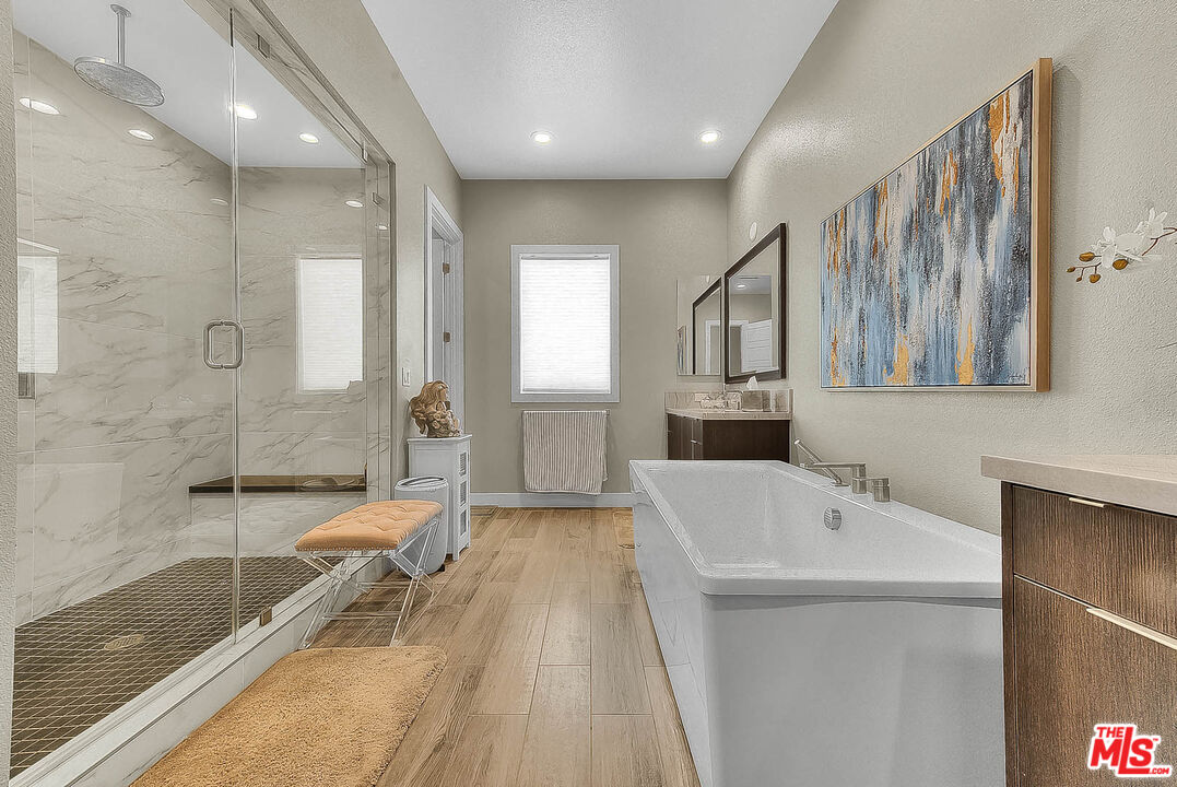 20558 Overlook Court Porter Ranch, CA 91326 - Photo 22 of 48 a bathroom with a tub sink shower and mirror