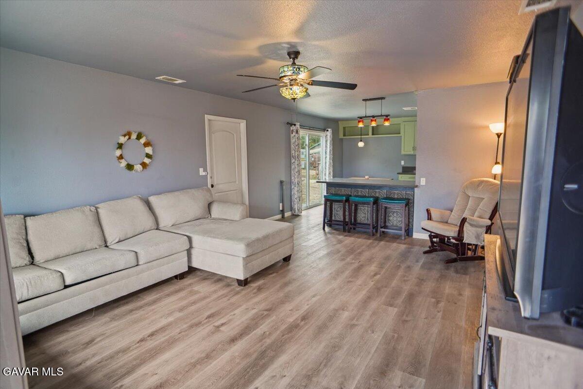 40287 Fieldspring Street Palmdale, CA 93591 - Photo 3 of 15 a living room with furniture and a chandelier
