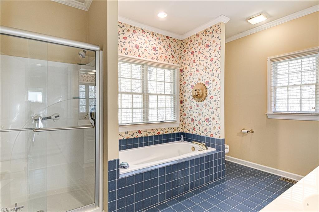 4511 Calabria Court High Point, NC 27265 - Photo 21 of 40 Separate shower, garden tub in primary bedroom's bath.