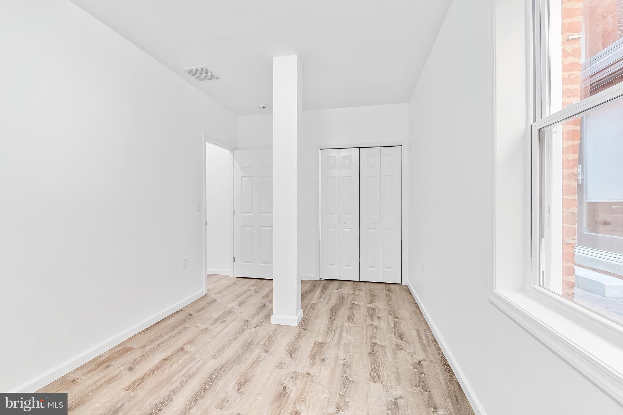 665 Washington Boulevard Baltimore, MD 21230 - Photo 11 of 21 a view of room with window and hardwood floor