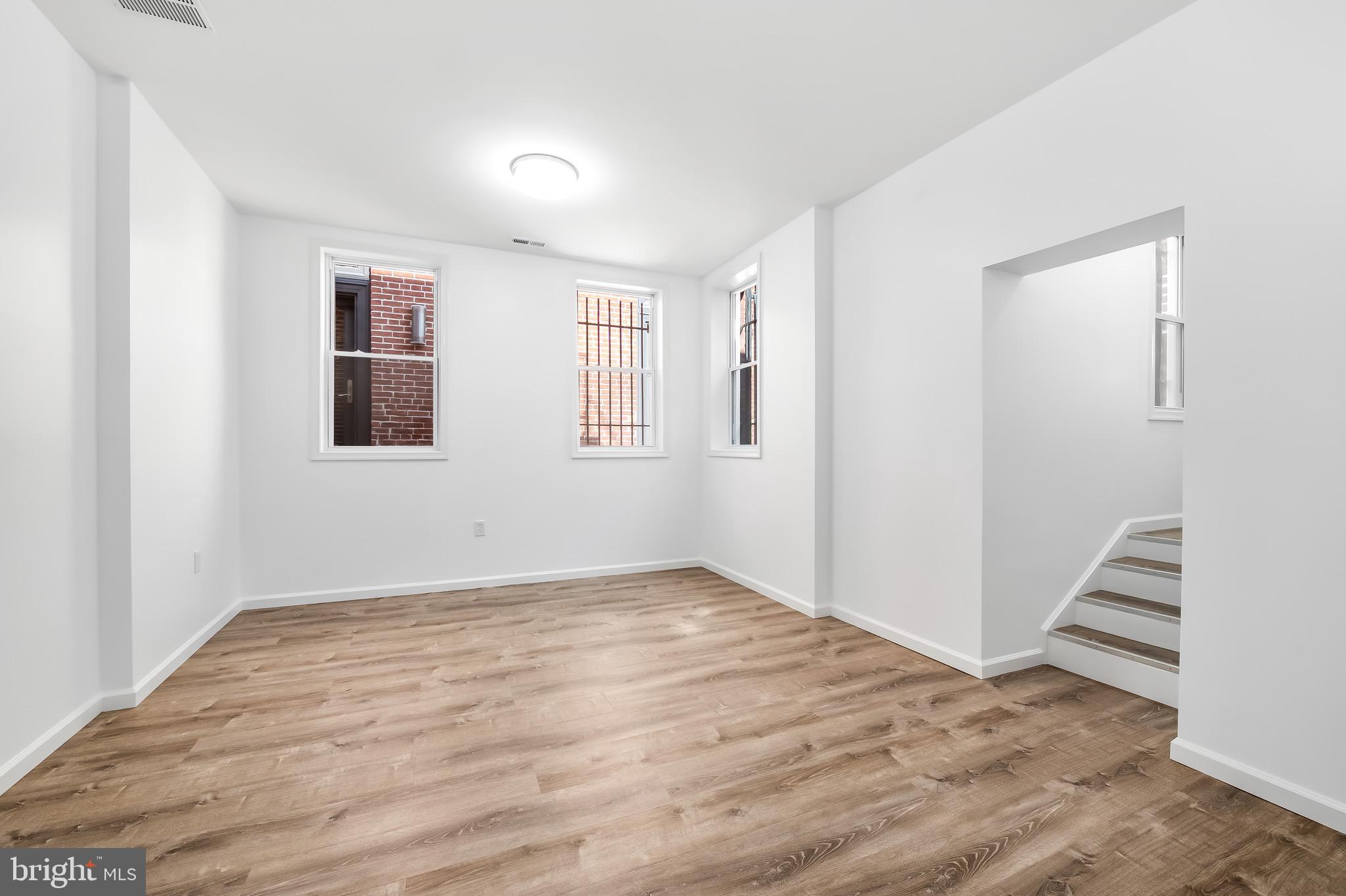 665 Washington Boulevard Baltimore, MD 21230 - Photo 13 of 21 an empty room with wooden floor and windows