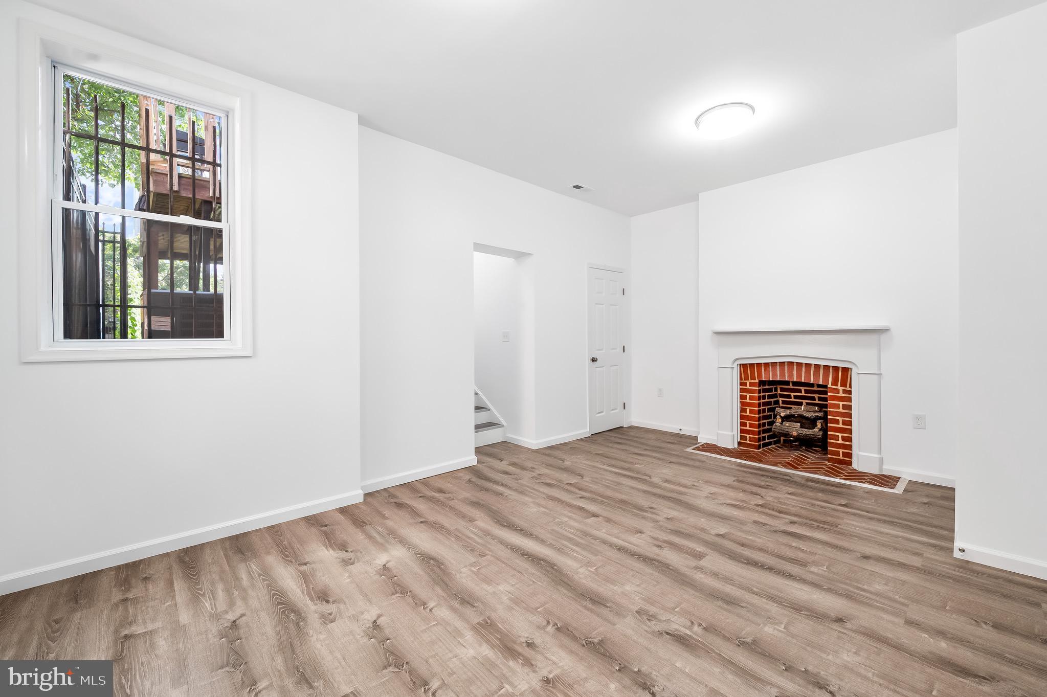 665 Washington Boulevard Baltimore, MD 21230 - Photo 14 of 21 a view of an empty room with a window and fire place
