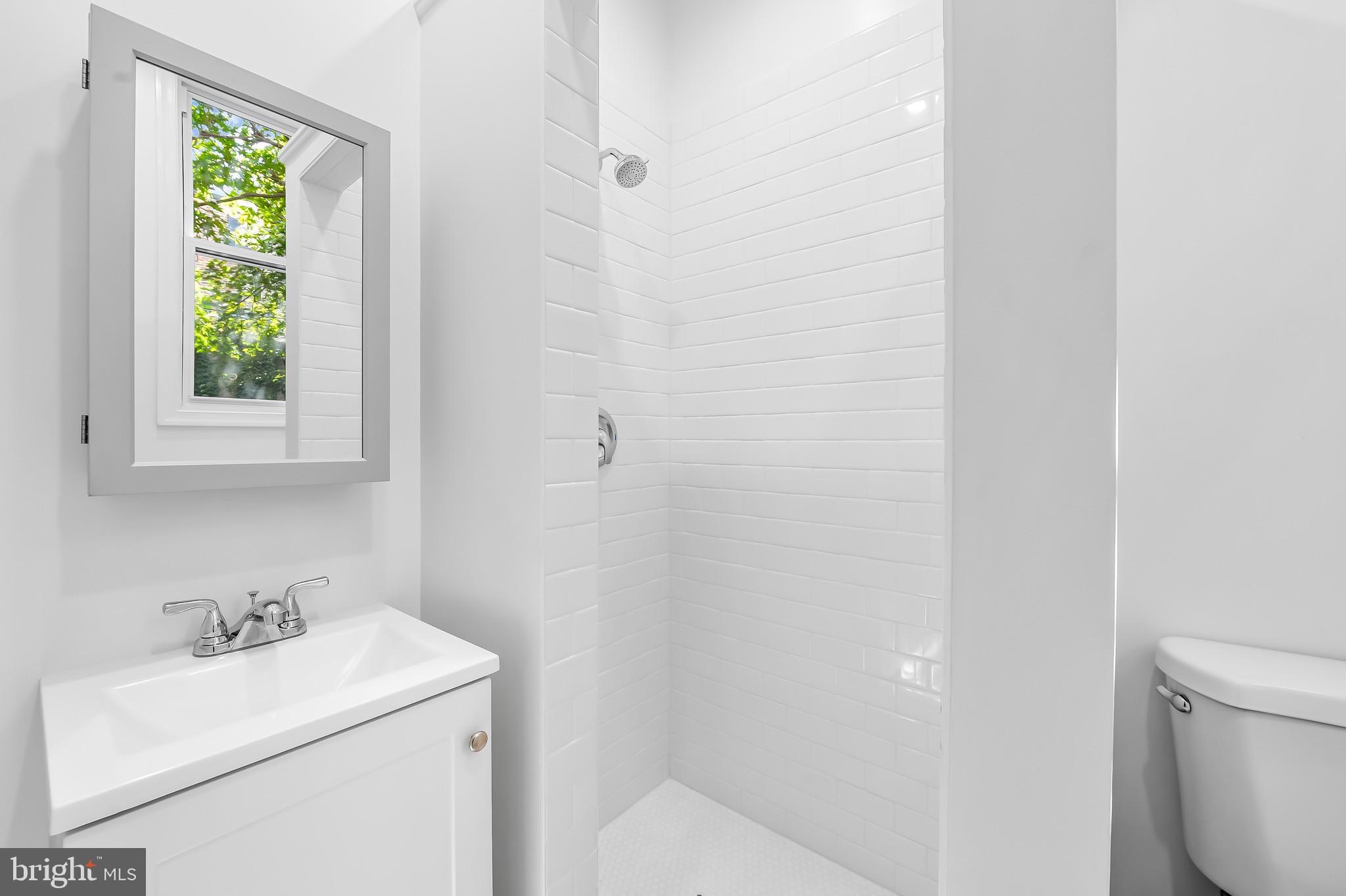 665 Washington Boulevard Baltimore, MD 21230 - Photo 15 of 21 a bathroom with a sink toilet and a window