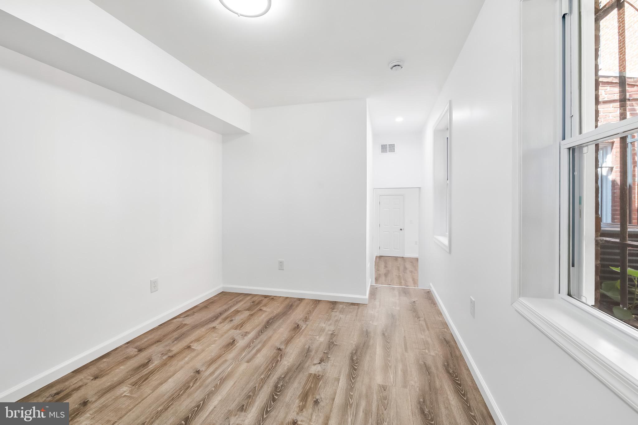 665 Washington Boulevard Baltimore, MD 21230 - Photo 16 of 21 a view of a room with wooden floor and window