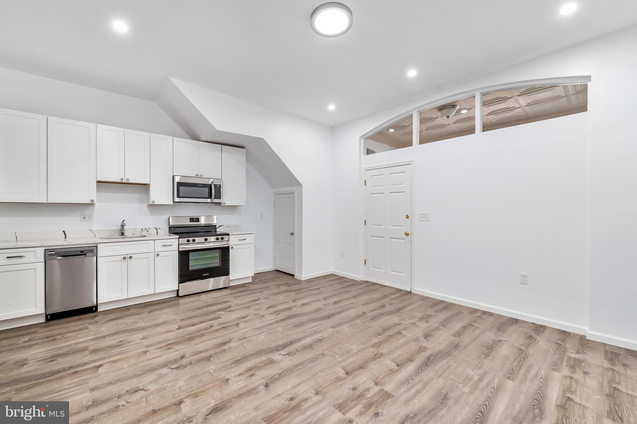 665 Washington Boulevard Baltimore, MD 21230 - Photo 4 of 21 a kitchen with granite countertop white cabinets and white appliances