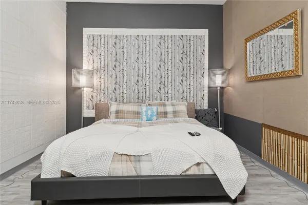 a bedroom with a bed and window