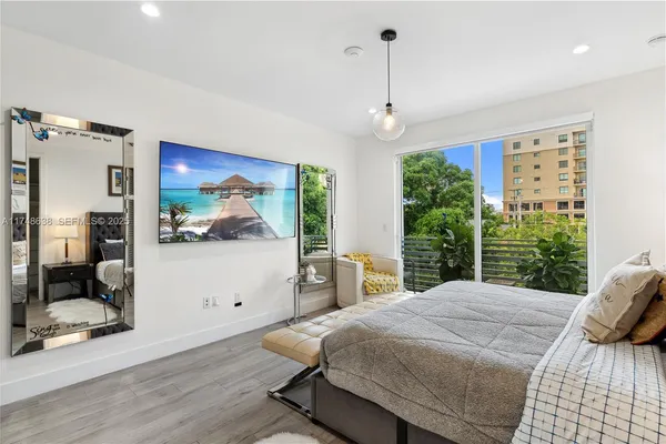 a bedroom with a large bed and a chandelier