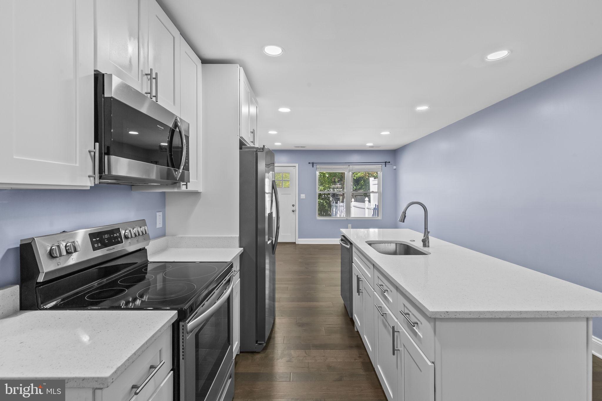 7602 Oxman Road Landover, MD 20785 - Photo 5 of 17 a kitchen with a sink a stove and cabinets