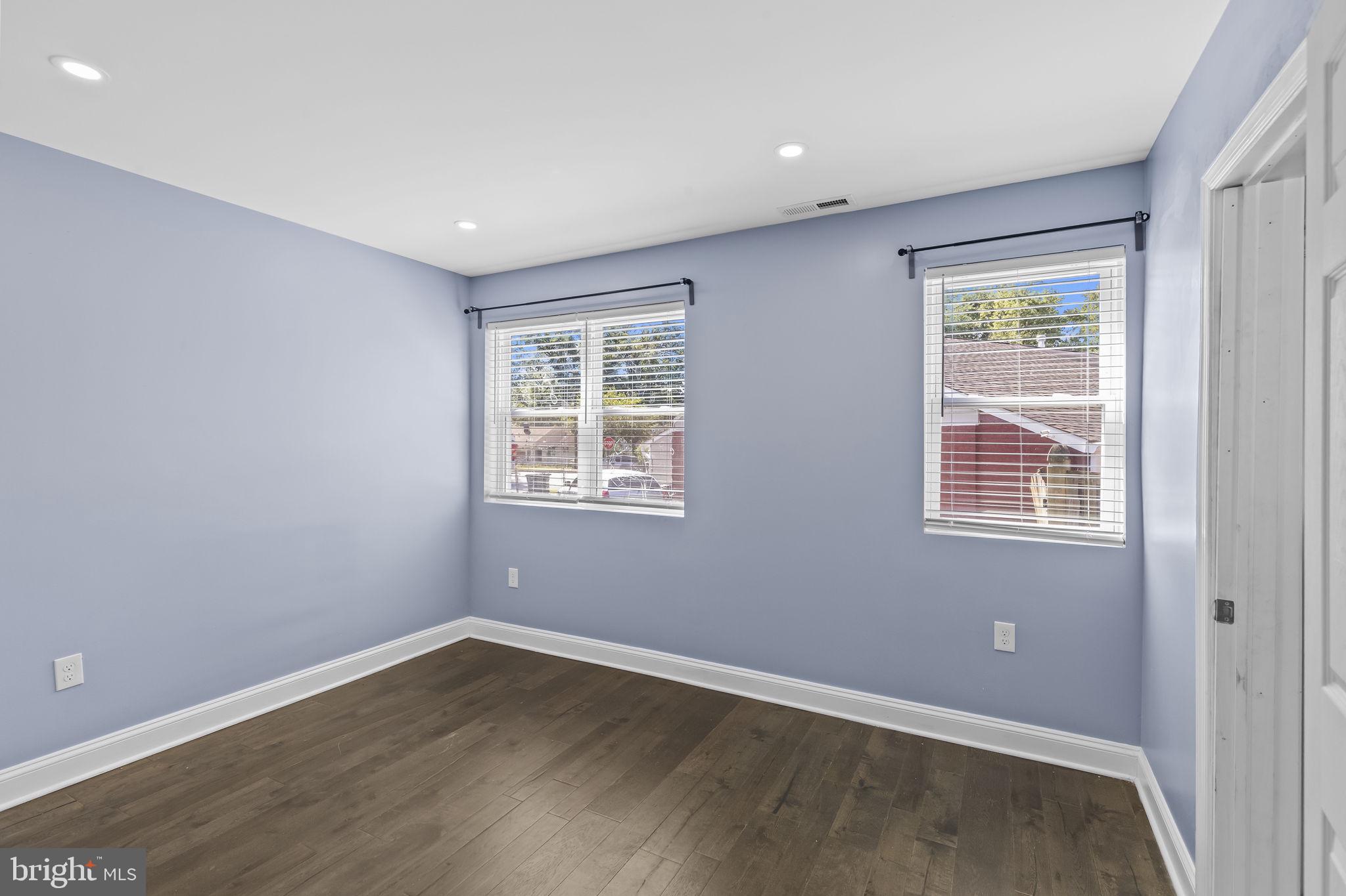 7602 Oxman Road Landover, MD 20785 - Photo 6 of 17 an empty room with wooden floor and windows
