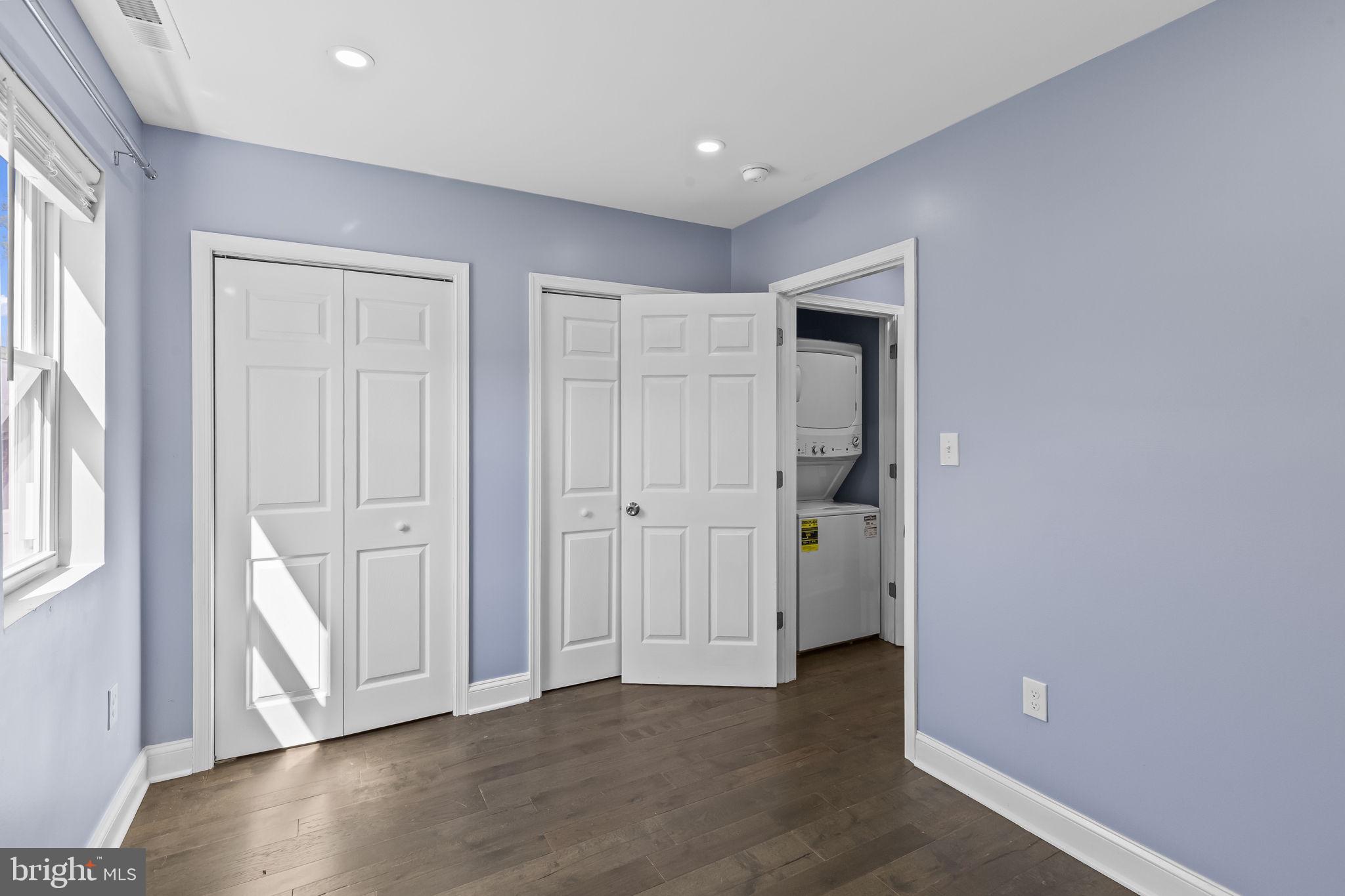 7602 Oxman Road Landover, MD 20785 - Photo 10 of 17 an empty room with wooden floor and windows