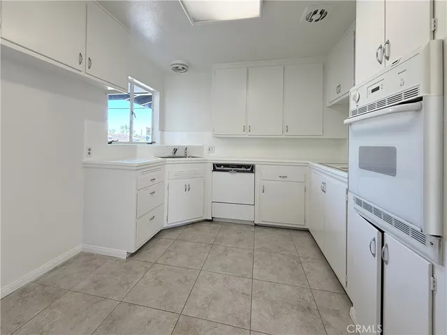 a kitchen with cabinets and window