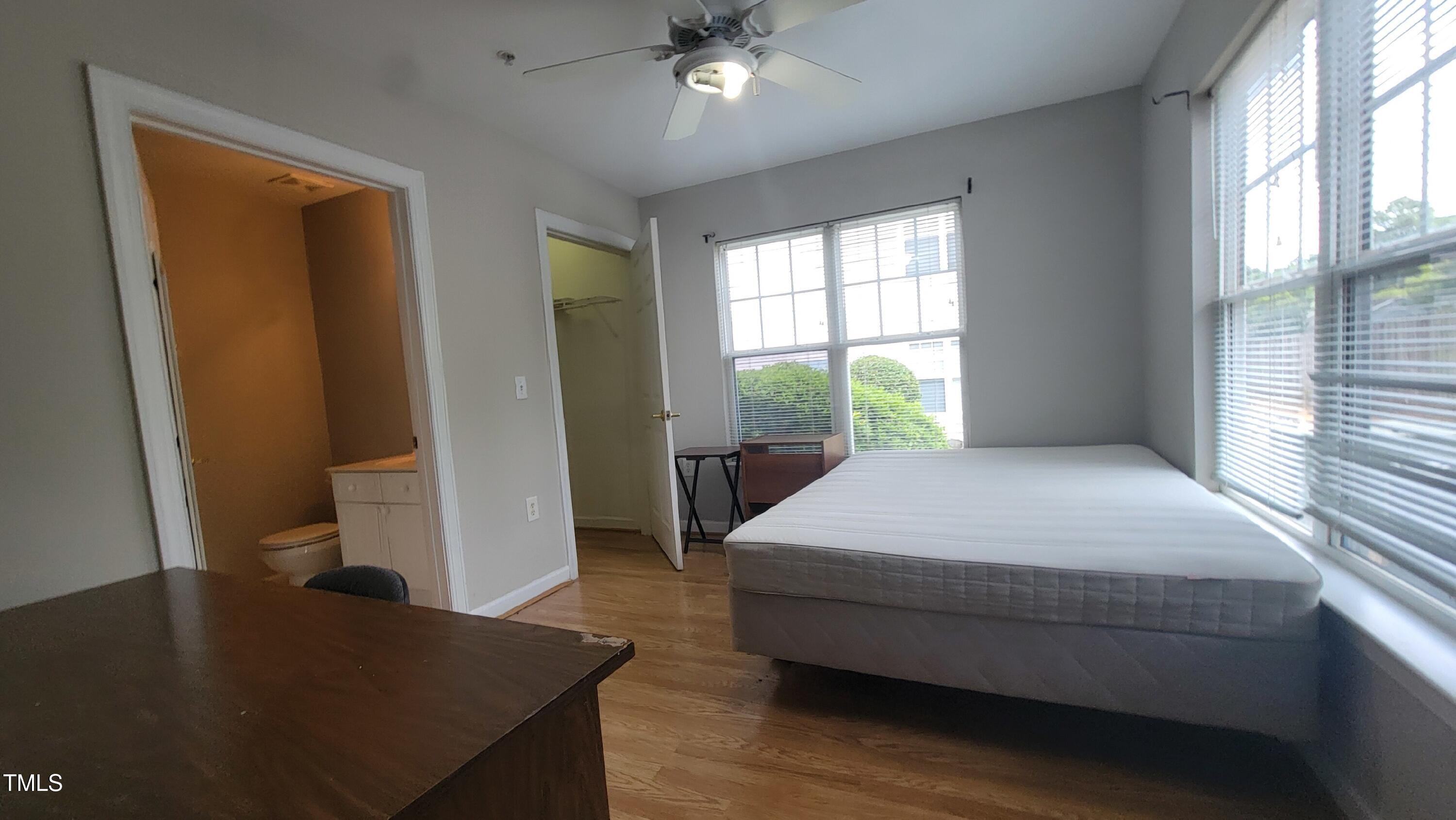 929 Morreene Road, Unit A13 Durham, NC 27705 - Photo 13 of 18 a bedroom with a bed and a table