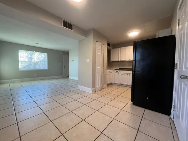 an empty room with wooden floor and closet
