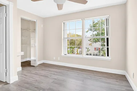 a view of empty room with wooden floor