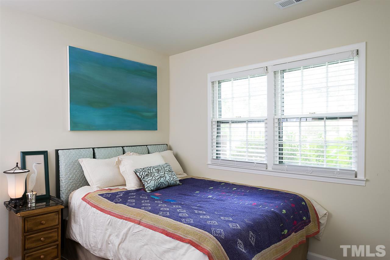 7713 Prospector Place Raleigh, NC 27615 - Photo 12 of 18 a bed sitting in a bedroom next to a window