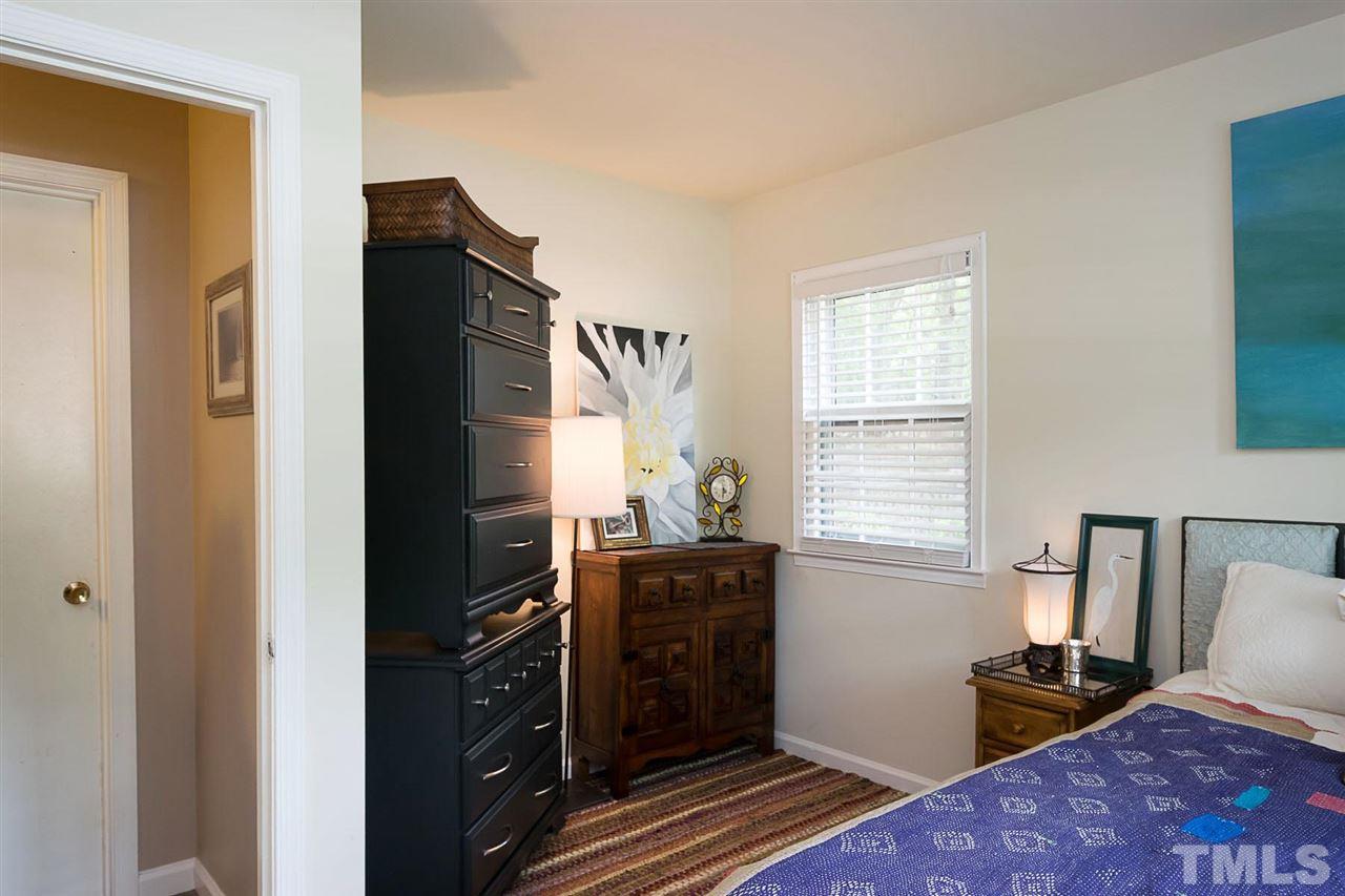 7713 Prospector Place Raleigh, NC 27615 - Photo 13 of 18 a bedroom with a bed and wooden floor