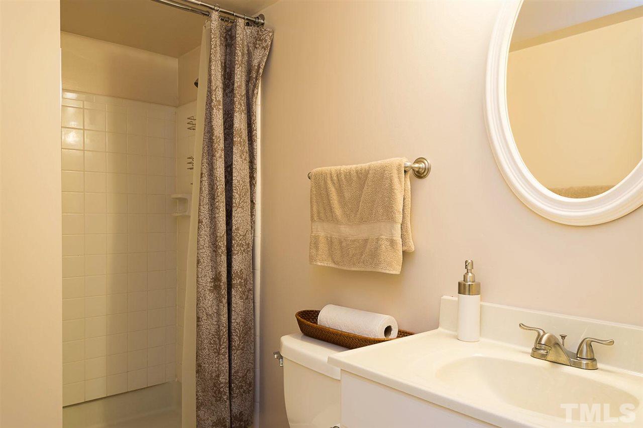 7713 Prospector Place Raleigh, NC 27615 - Photo 14 of 18 a bathroom with a sink and a mirror