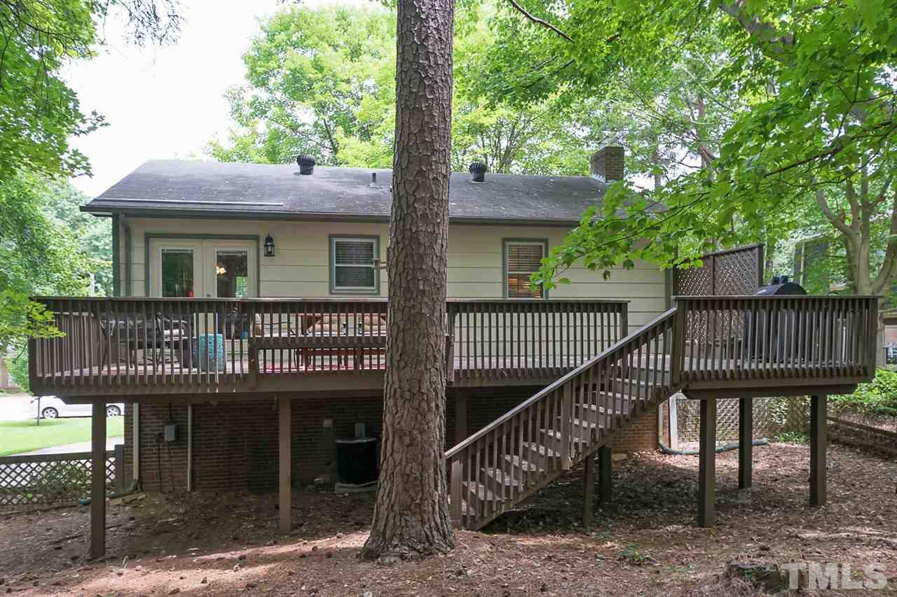 7713 Prospector Place Raleigh, NC 27615 - Photo 18 of 18 a view of a house with a deck and a yard