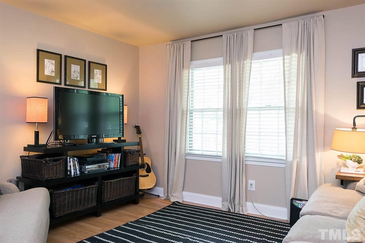 7713 Prospector Place Raleigh, NC 27615 - Photo 3 of 18 a living room with furniture and a flat screen tv