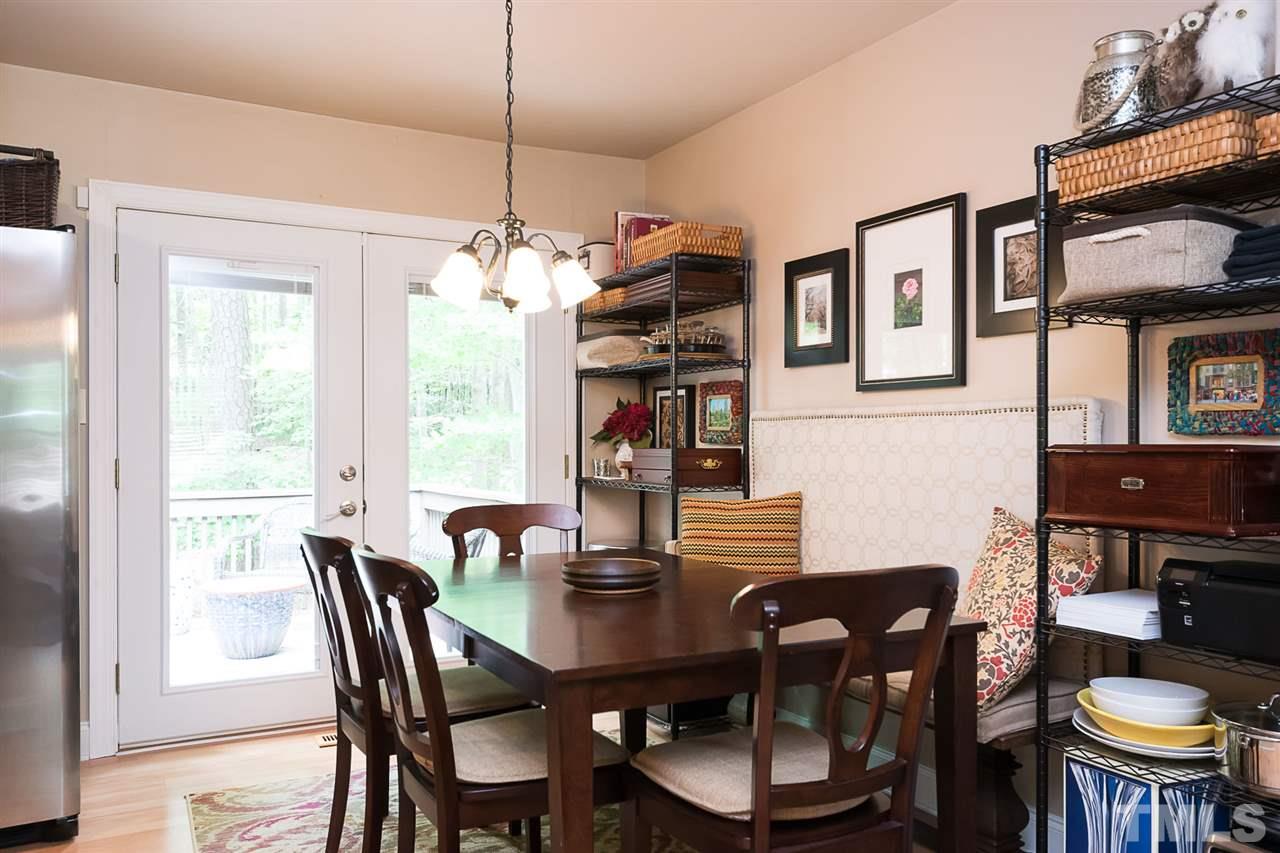 7713 Prospector Place Raleigh, NC 27615 - Photo 5 of 18 a dining room with furniture a chandelier and window